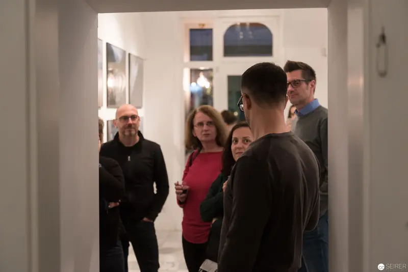 Wolf Hoffmann's Vernissage: Intimate Gallery Gathering of Photographers and Guests