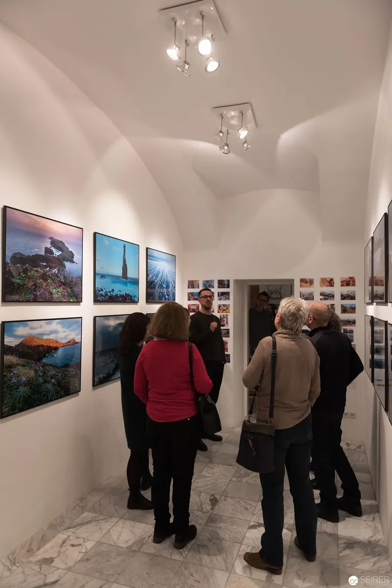 Wolf Hoffmann Photographic Exhibition: Viewers Examining Landscape Imagery at Gallery Vernissage