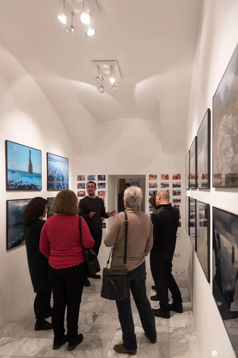 Wolf Hoffmann Vernissage: Gallery Visitors Examining Photographic Exhibition in Vienna