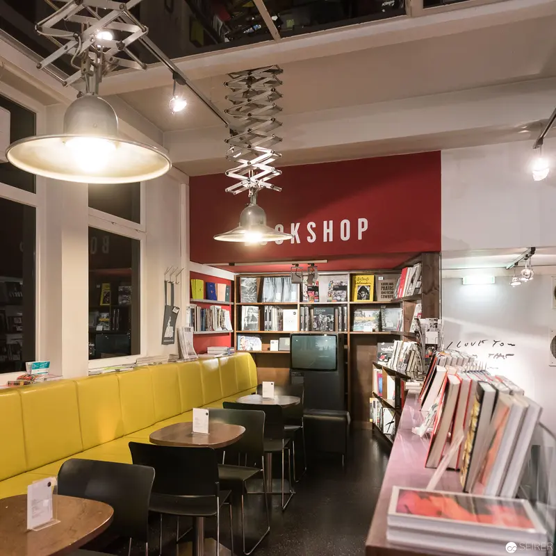 Bookshop Interior with Yellow Seating and Ambient Lighting at Westlicht, Vienna