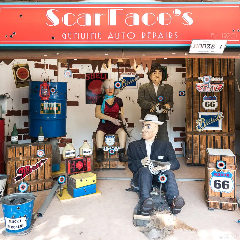 Scarface's Auto Repairs: Nostalgic Americana Tableau with Vintage Signage and Mechanical Figures