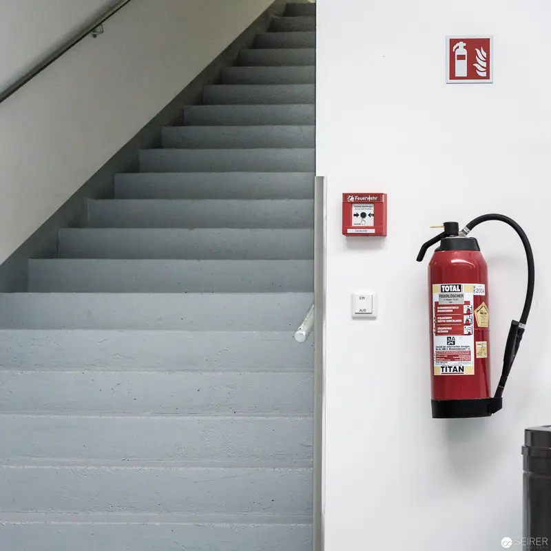 Minimalist Safety Composition: Fire Extinguisher and Stairwell at Brotfabrik, Vienna 2017