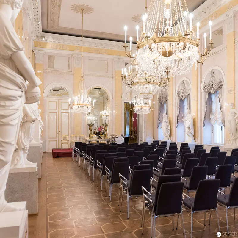 Ornate Ceremonial Hall with Crystal Chandeliers and Modern Seating Arrangement