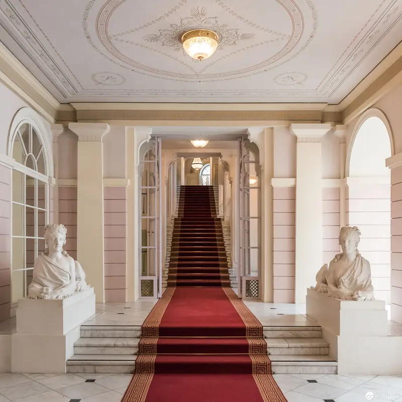 Neoclassical Interior with Marble Busts and Grand Central Staircase