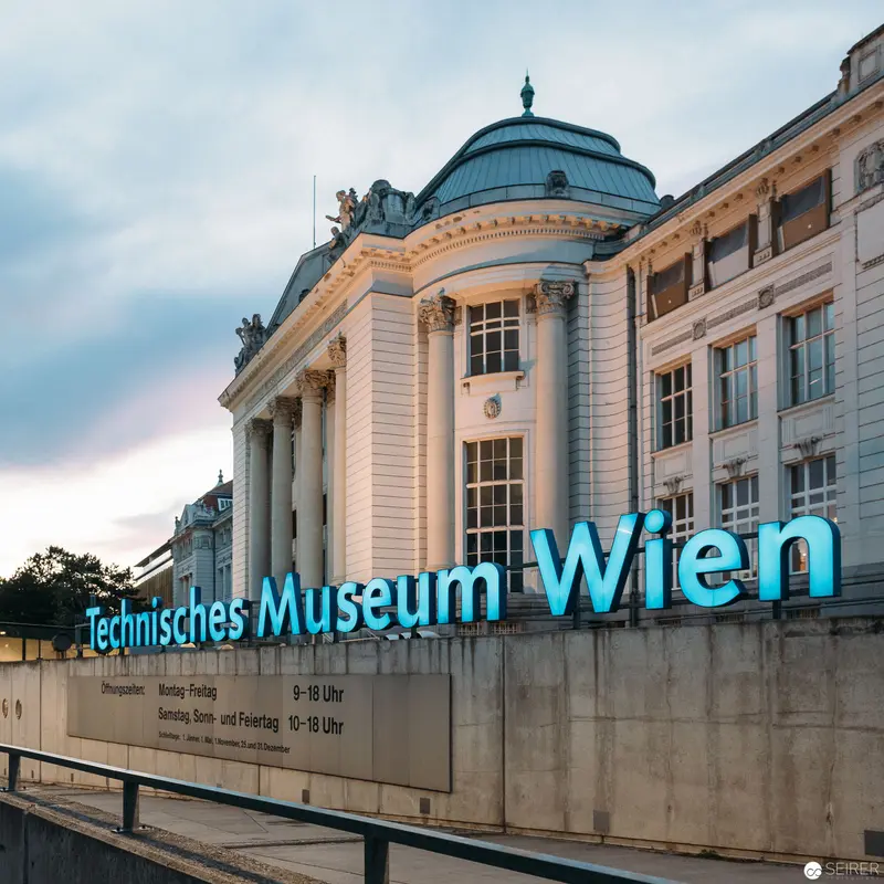 Vienna's Technisches Museum Facade at Twilight: Neoclassical Architecture and Modern Signage
