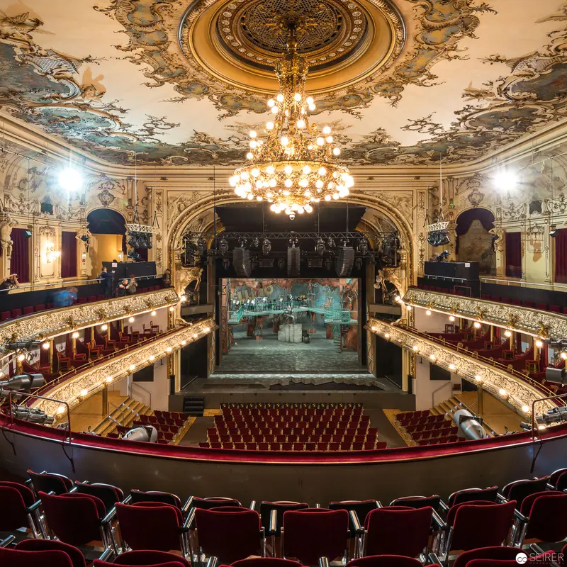 Ornate 19th-Century Viennese Theater Interior with Elaborate Baroque Stage and Chandelier