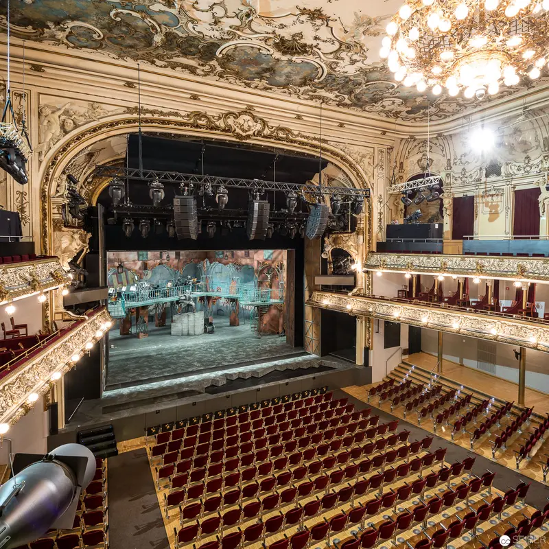 Ornate Vienna Theater Interior with Baroque Stage and Crimson Seating