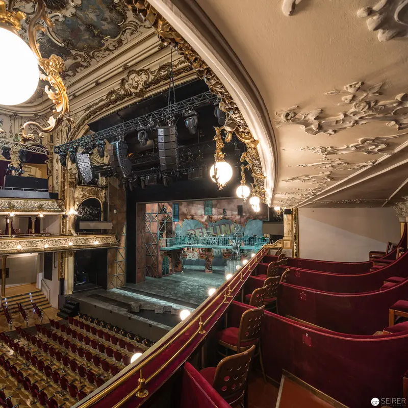Ornate Ronacher Theater Interior with Dramatic Stage and Crimson Opera Boxes