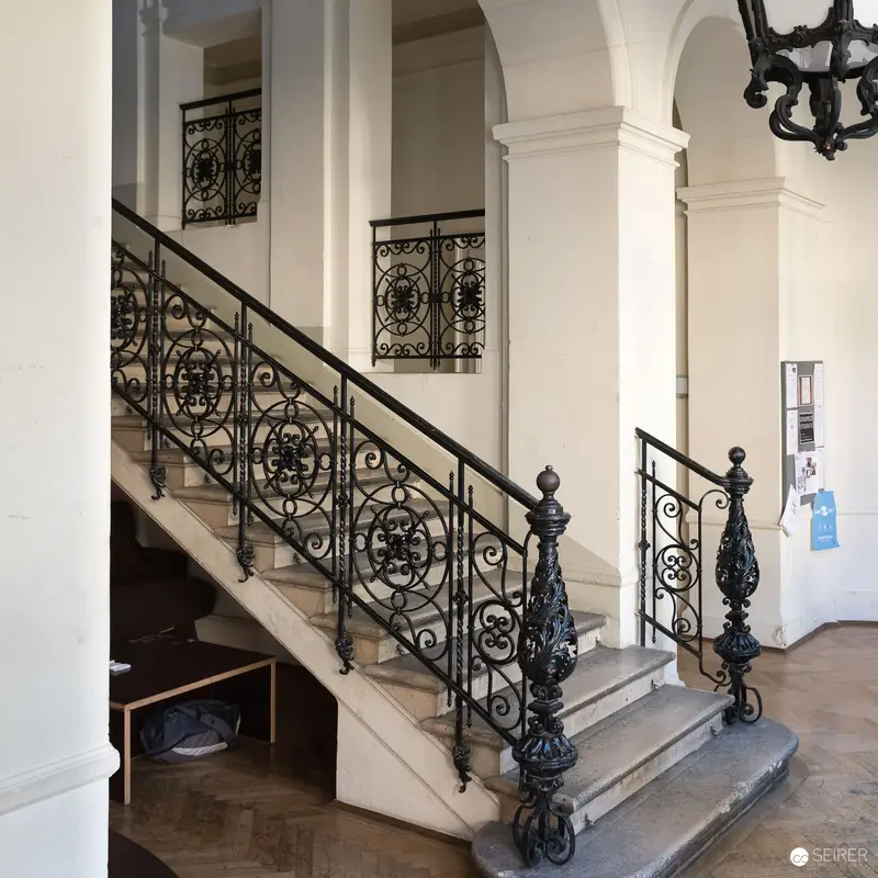 Ornate Staircase with Intricate Wrought-Iron Railing at Max Reinhardt Seminar