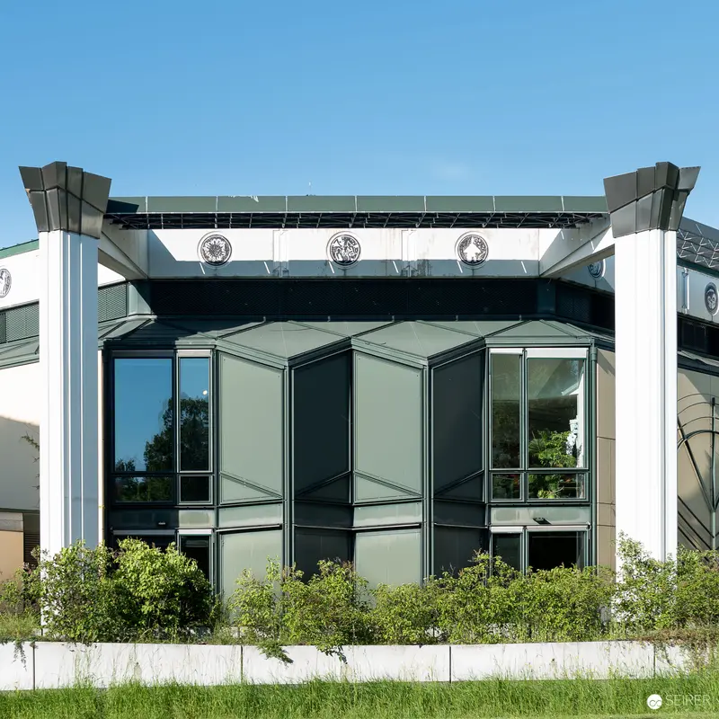 Geometric Architectural Facade with Modernist Glass and White Structural Elements