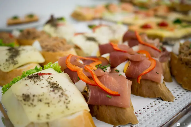 Gourmet Canapés with Ham and Cheese on Decorative Platter