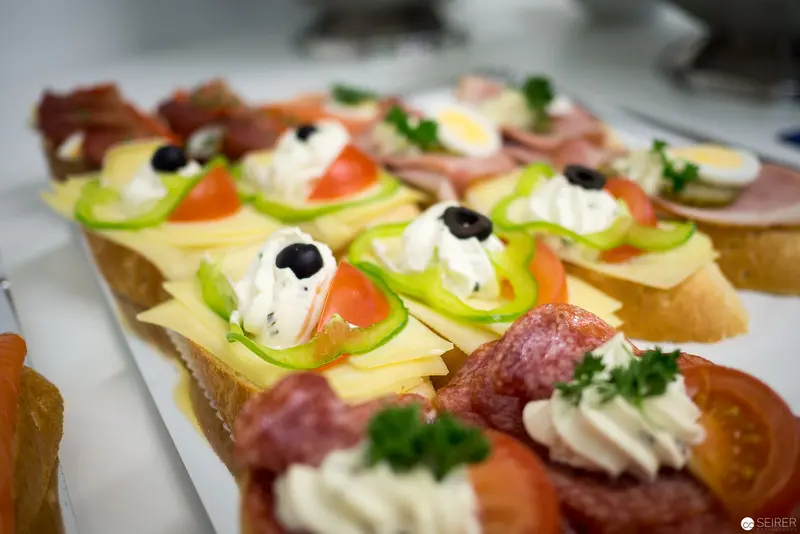 Artfully Composed Gourmet Canapés with Cheese, Vegetables, and Elegant Garnishes