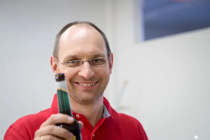 Microsoft Technologies Expert Smiling and Holding Marker at Linz User Group Meeting