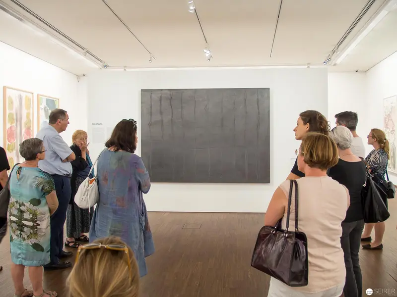 Contemplative Viewers Engaging with Minimalist Gray Canvas at Albertina Museum