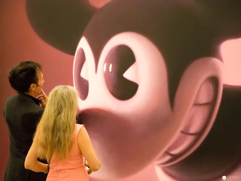 Visitors Contemplating Oversized Pink Mickey Mouse Portrait at Albertina Vienna