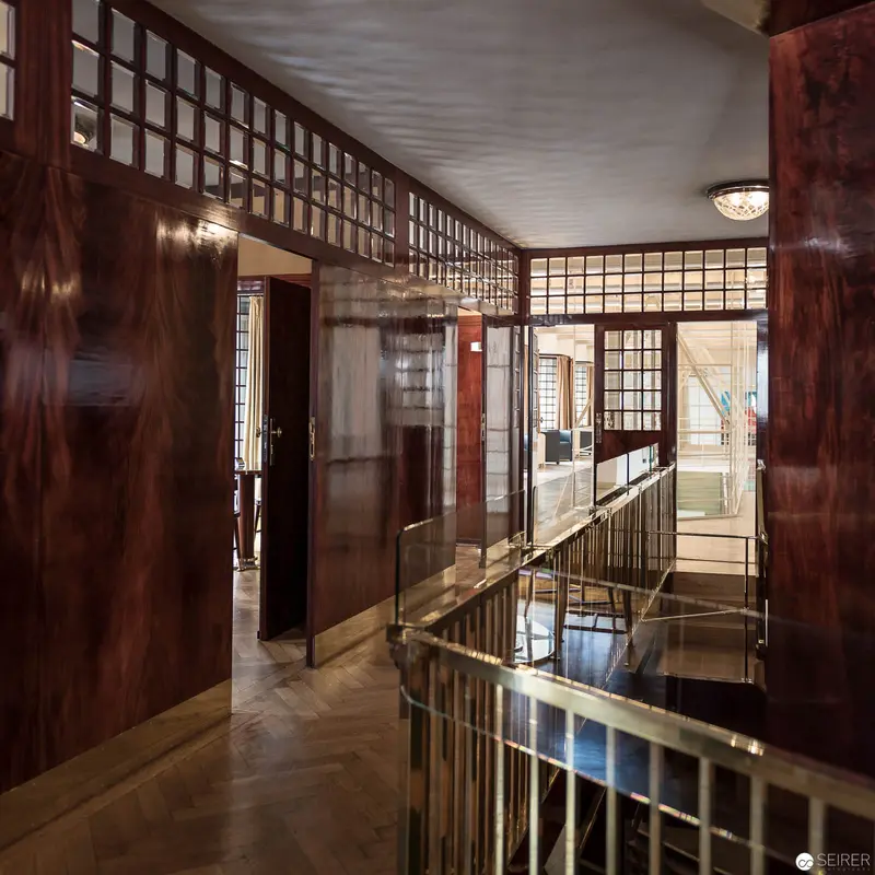 Interior Corridor with Wooden Paneling and Glass Partitions in Modernist Design