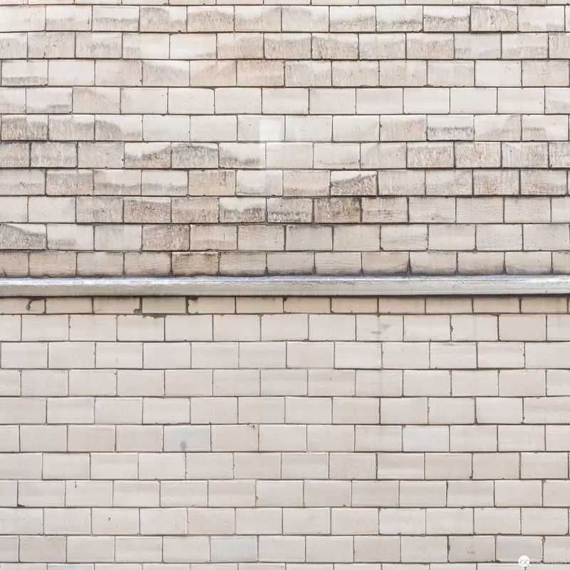 Textural Masonry Study: Weathered Brick Wall with Horizontal Metal Divider