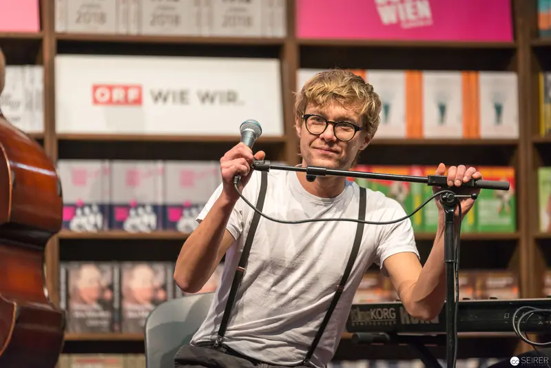 Performer at ORF Studio with Microphone and Curly Hair