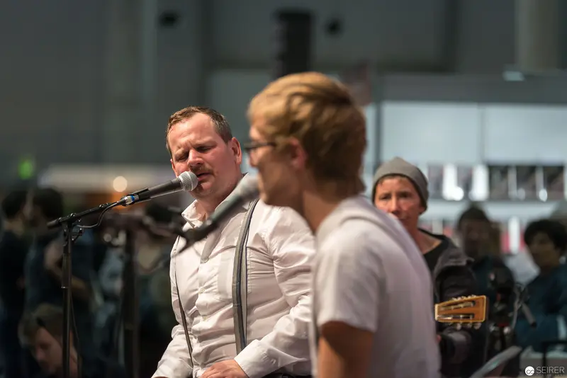 Musicians Performing on Stage with Microphone and Intense Expression