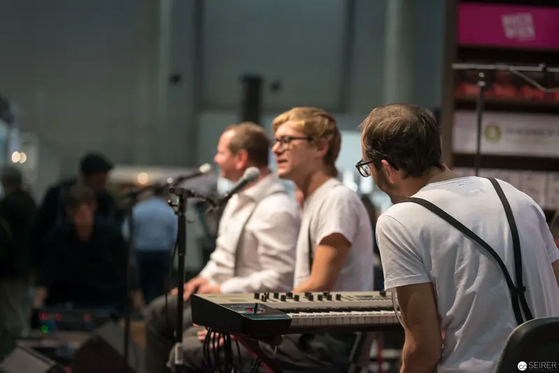 Electronic Music Trio Performing with Keyboards at Live Concert Event