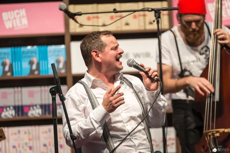Passionate Vocal Performance at Live Musical Event with Double Bass Accompaniment
