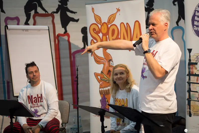 Spona Event Speakers Presenting with Animated Backdrop and Microphone