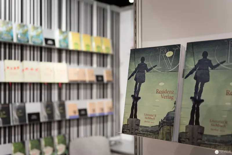 Residenz Verlag Book Display at Literary Exhibition with Silhouetted Figure