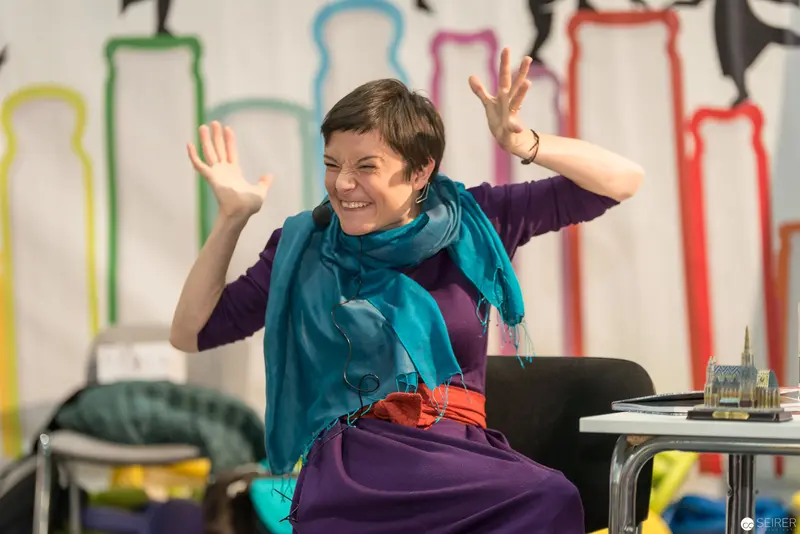 Lena Raubaum Gesturing Animatedly During Creative Workshop Session