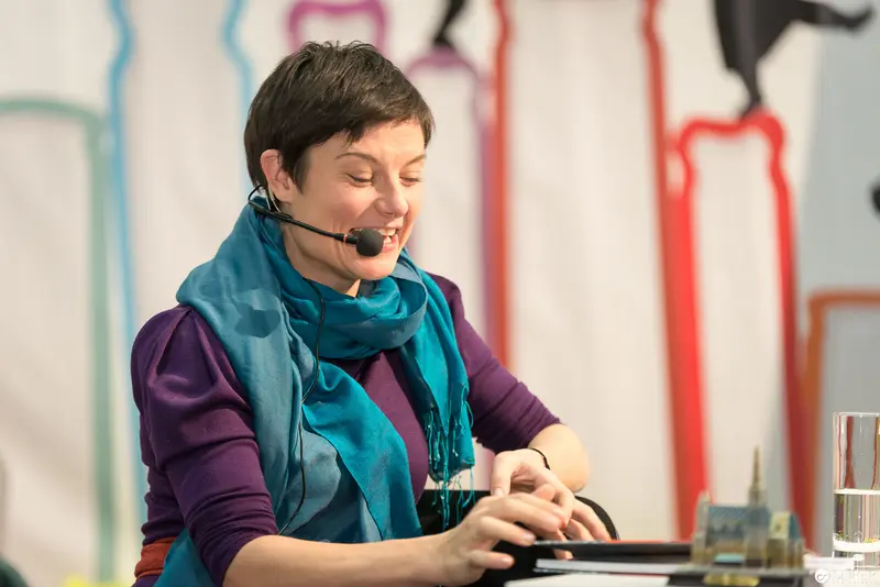 Professional Woman in Blue Scarf Engaged in Workplace Communication