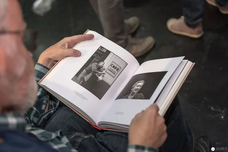 Reading Photographic Book at 2017 Wien Event with Intense Visual Focus