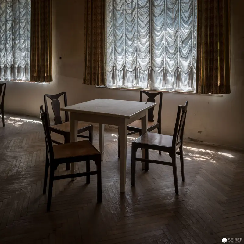 Minimalist Interior with White Table and Vintage Austrian Salon Curtains