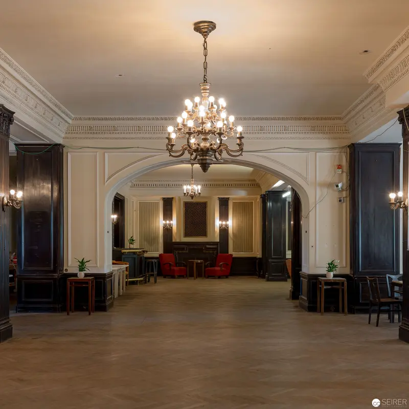 Opulent Architectural Interior with Grand Chandelier and Elegant Archway