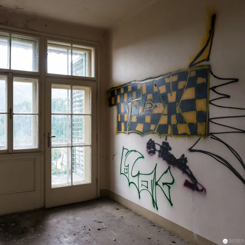 Abandoned Interior with Checkerboard Mural and Graffiti Wall Artwork