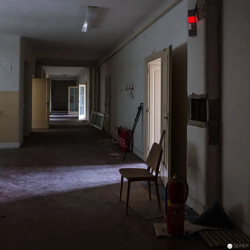 Institutional Interior with Chair and Corridor in Muted Monochromatic Tones