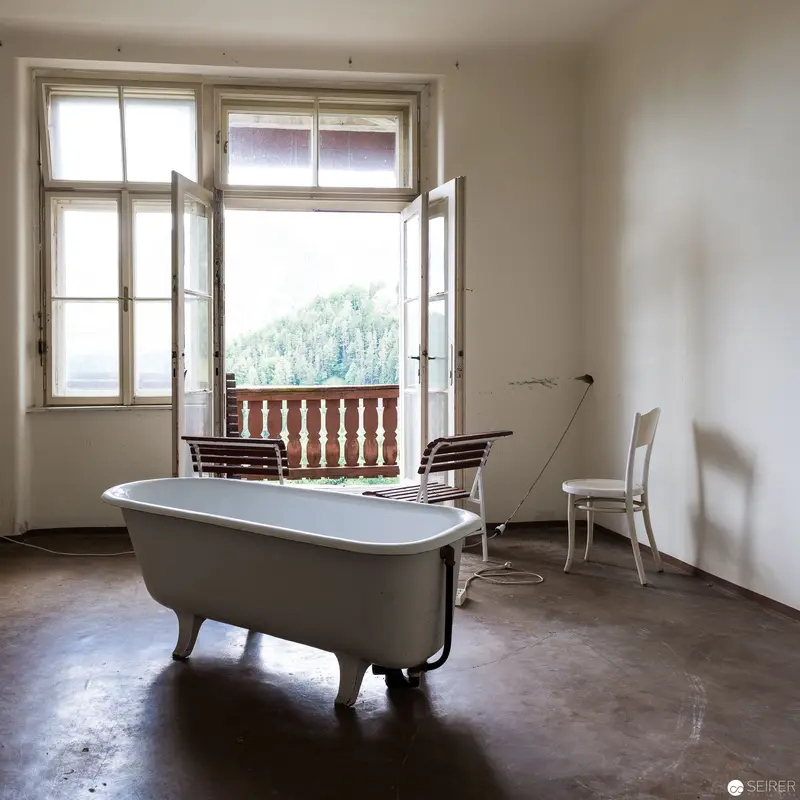 Vintage Bathtub in Minimalist Room with Balcony and Open Windows