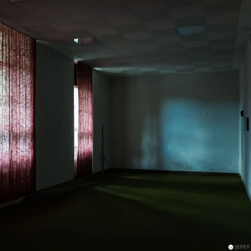 Liminal Space with Crimson Curtain and Blue-Tinted Wall in Desaturated Interior