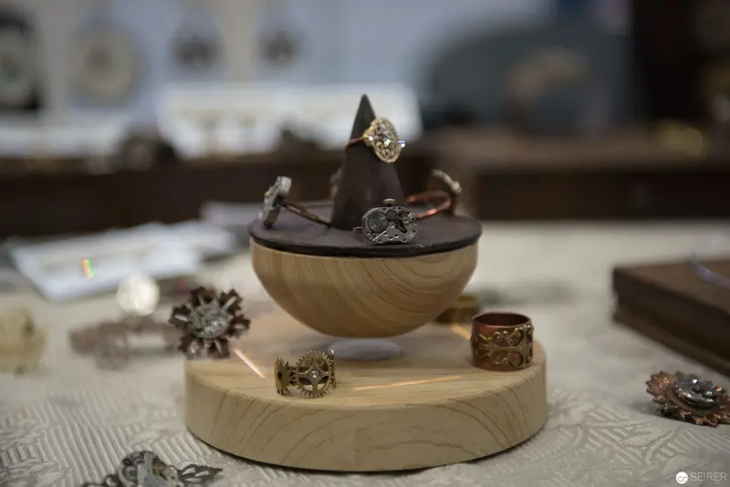 Artisan Jewelry Display with Wooden Risers and Metalwork Rings