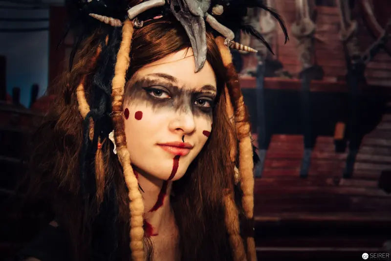 Ritualistic Portrait of Woman with Tribal Makeup and Ornate Headdress