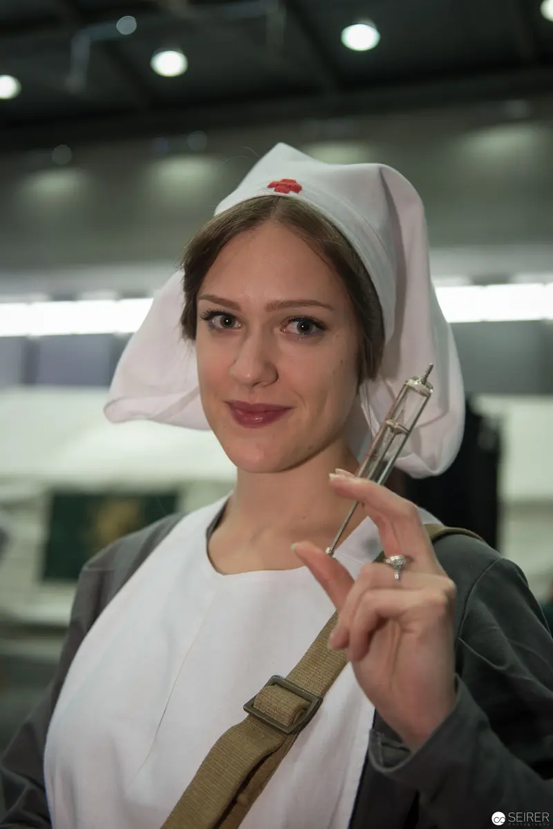 Nurse in White Uniform Holding Medical Tool in Professional Setting