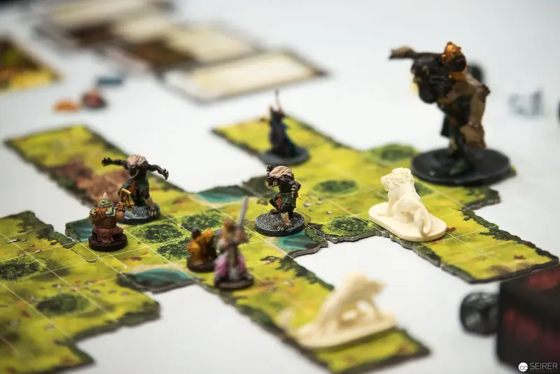 Miniature Fantasy Game Scenario with Detailed Figurines on Modular Terrain Tiles