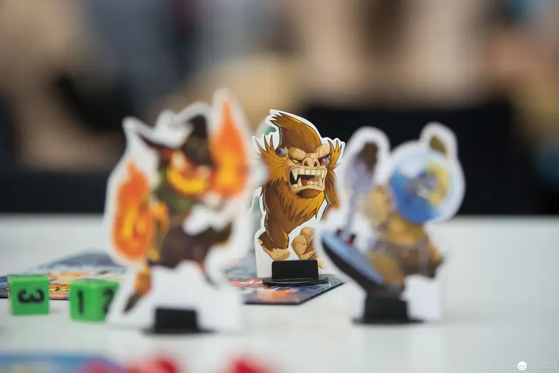 Miniature Board Game Figurines in Blurred Tabletop Strategic Deployment