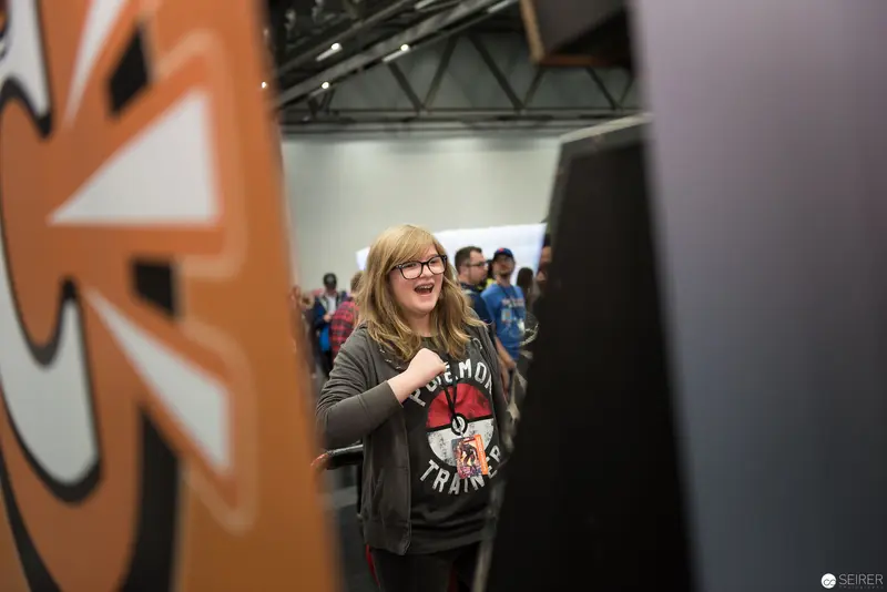 Attendee in Pokemon Trainer Hoodie at Conference Event