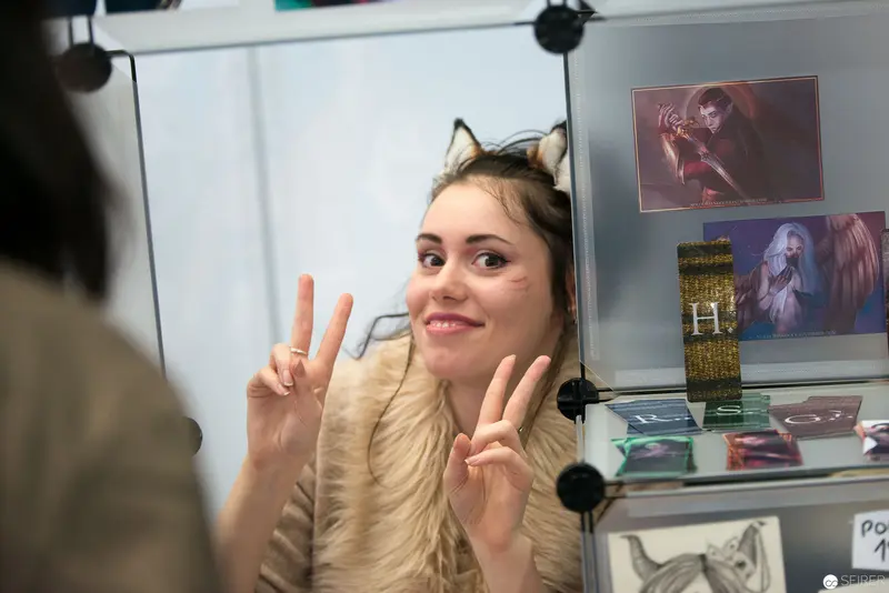 Artist with Cat Ears Making Peace Signs at Creative Workspace