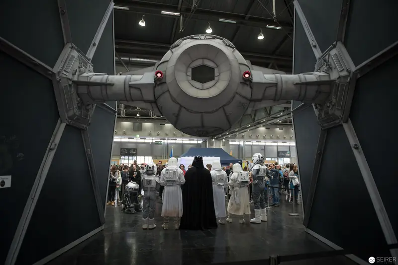 Star Wars TIE Fighter Replica at Cosplay Convention with Attendees in Costume