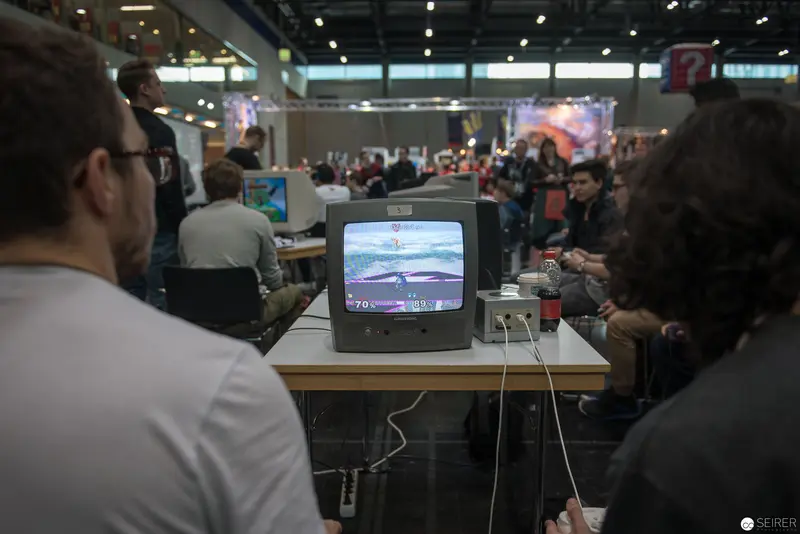 Retro Gaming Display at Crowded Convention, Vintage Television Screen Centered