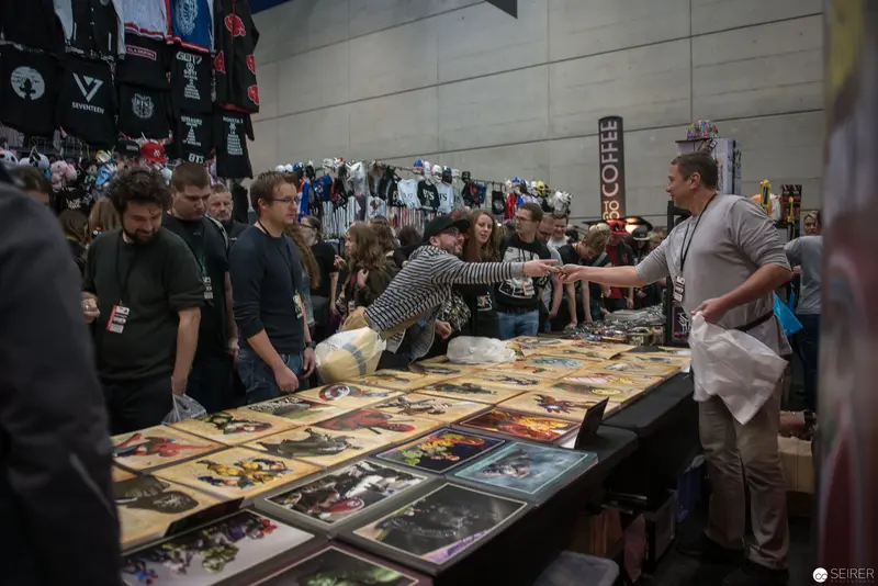 Convention Booth Displaying Graphic Art Prints at Fan Gathering