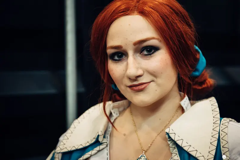 Portrait of a Red-Haired Woman in White and Blue Patterned Jacket