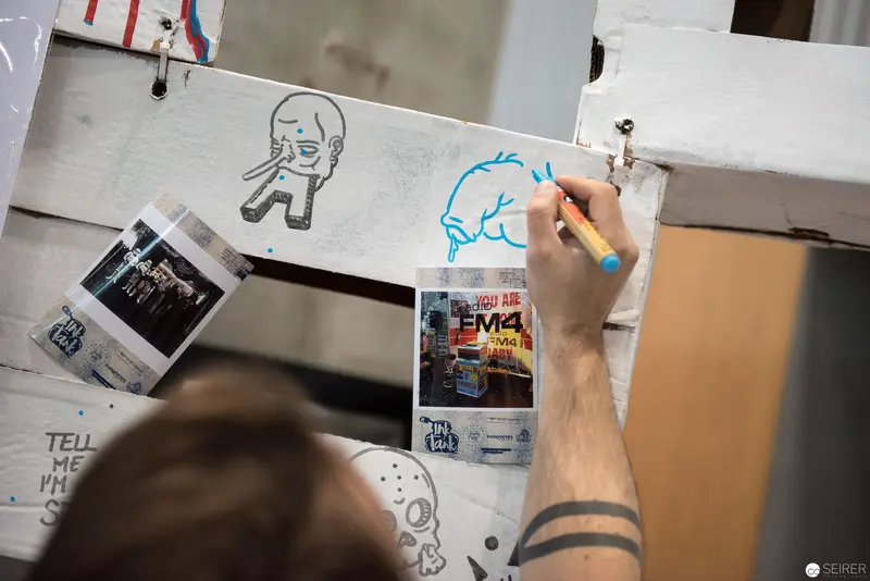 Street Artist Drawing Cartoon Characters on Urban Display Board