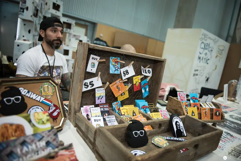 Artisan Vendor's Merchandising Display with Graphic Design Prints and Wooden Crate