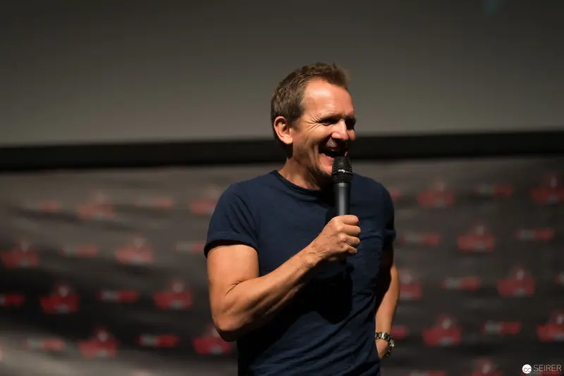 Comedian Performing Standup on Stage with Microphone and Passionate Expression